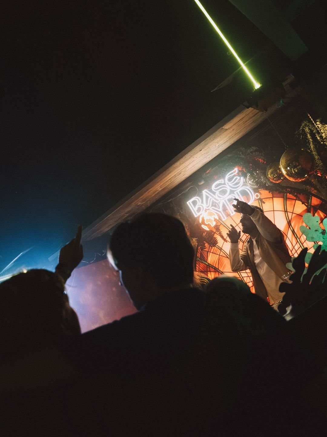 Hands in the air in front of the BaseYRD neon sign at LouLou, Eindhoven