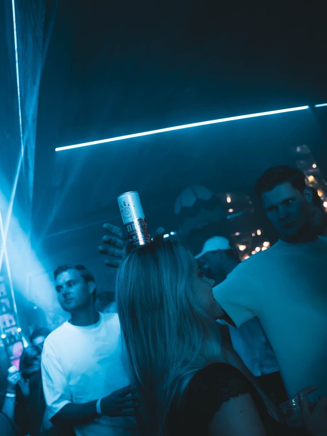 Crowd dancing under a blue light beam at LouLou, Eindhoven